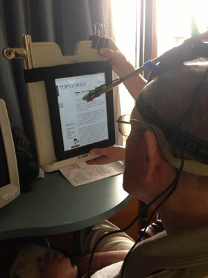 Participant (P1) accessing his iPad device using makeshift head pointer